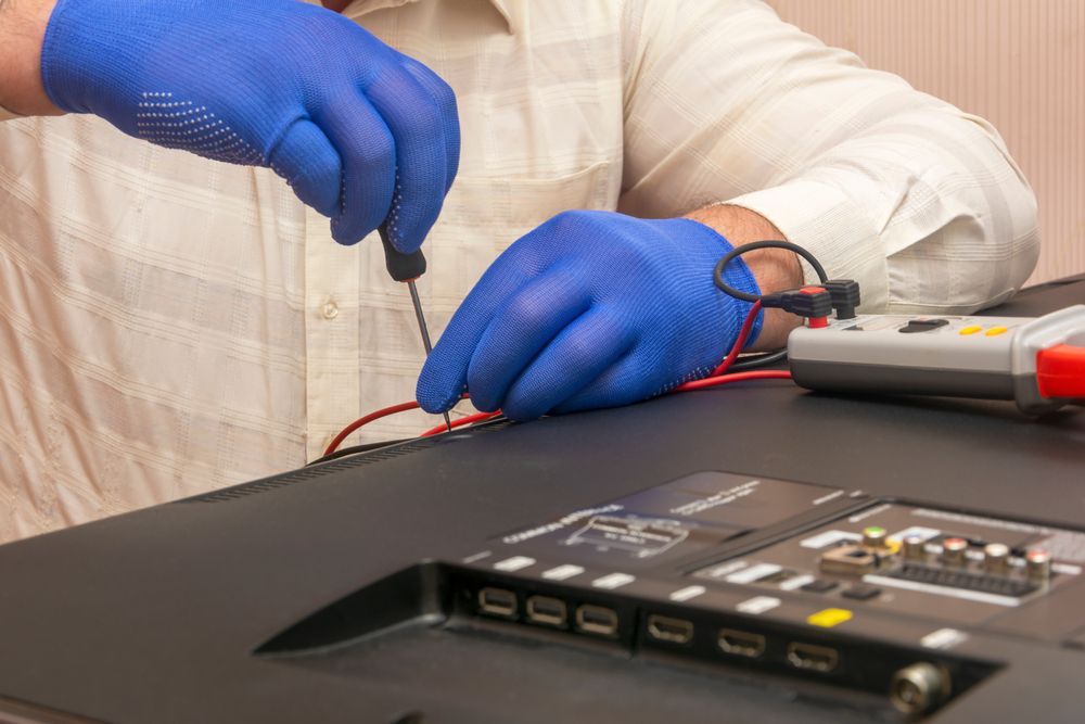 Engineer in gloves with screwdriver - Antenna Services in West Gosford, NSW
