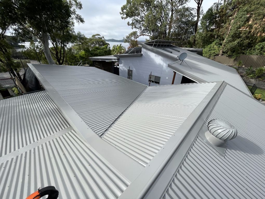 The Roof of a House With a Satellite Dish on It — Platinum Pride Roofing In Gosford, NSW