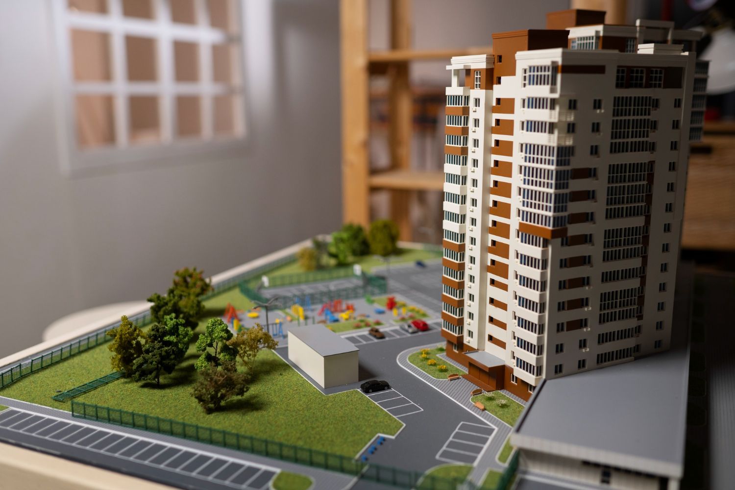 A model of a building with a lot of windows is sitting on a table.