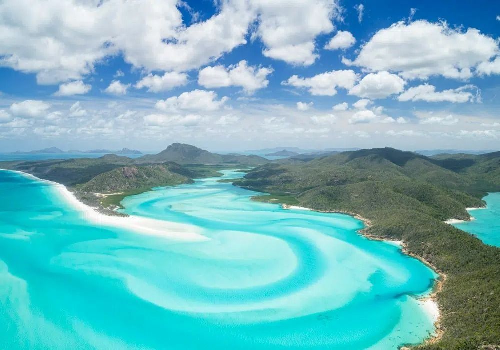 Aerial view of the swirling turquoise waters and white sands of Hill Inlet at Whitehaven Beach in the Whitsundays.