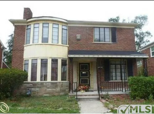 A brick house with a lot of windows is for sale