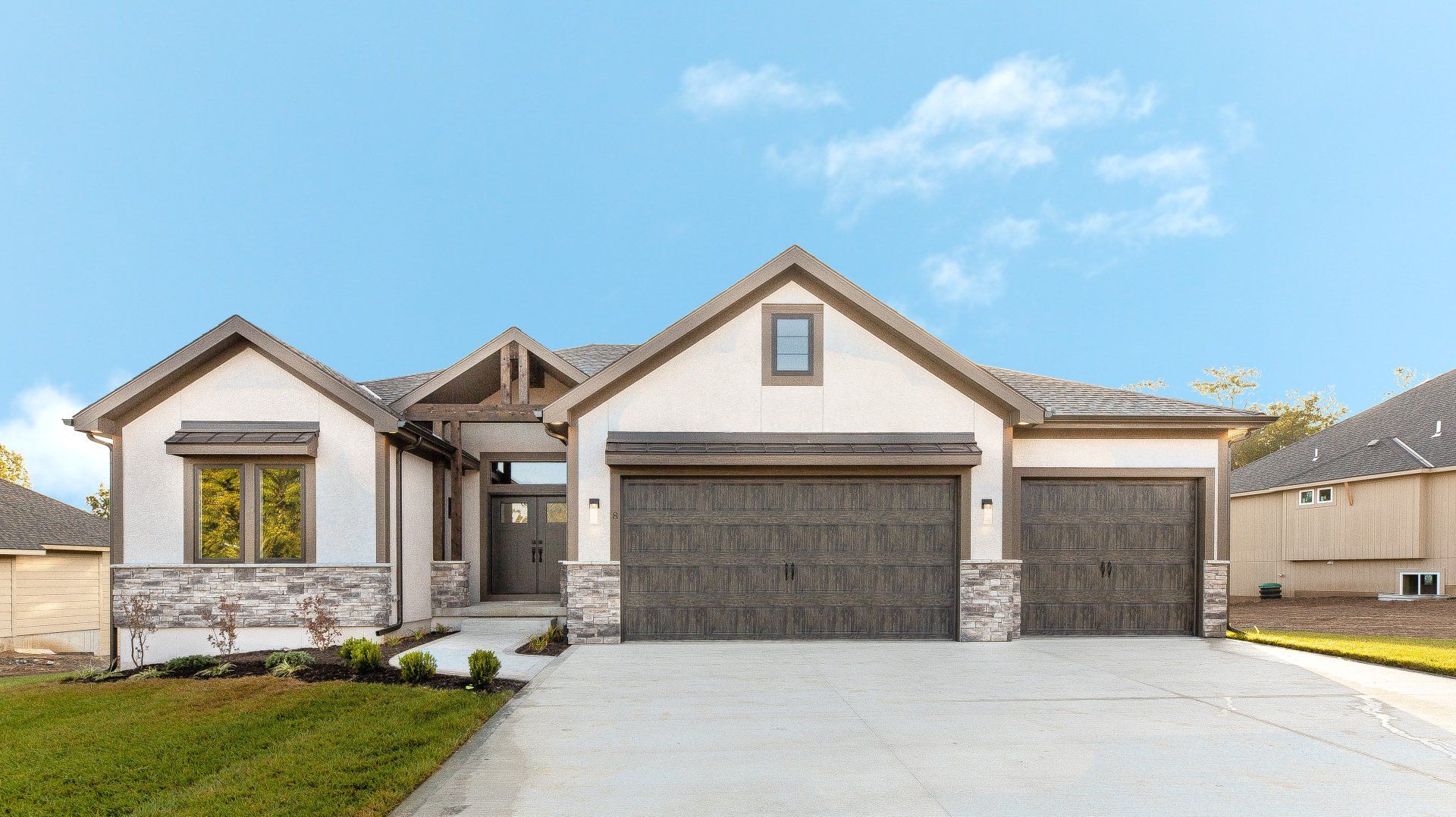The front of a house with two garages and a driveway.