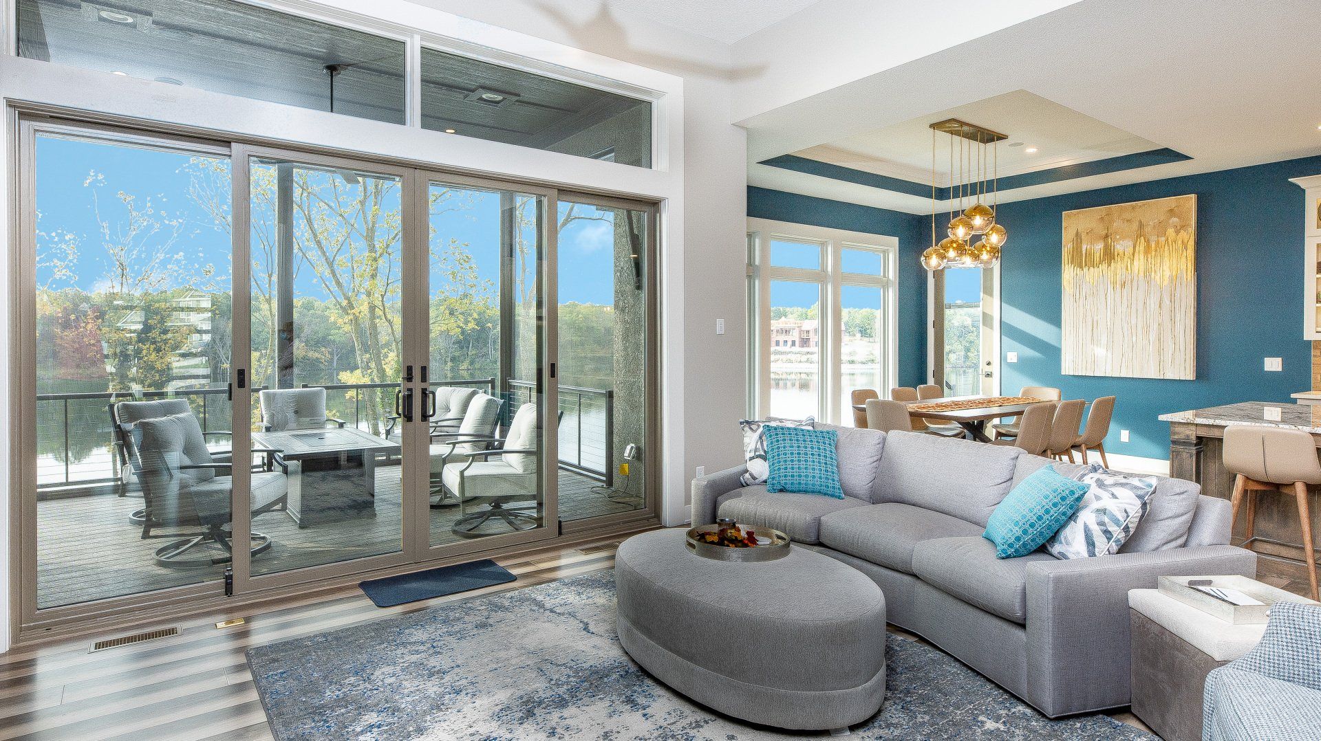 A living room with a couch , table , chairs and sliding glass doors.