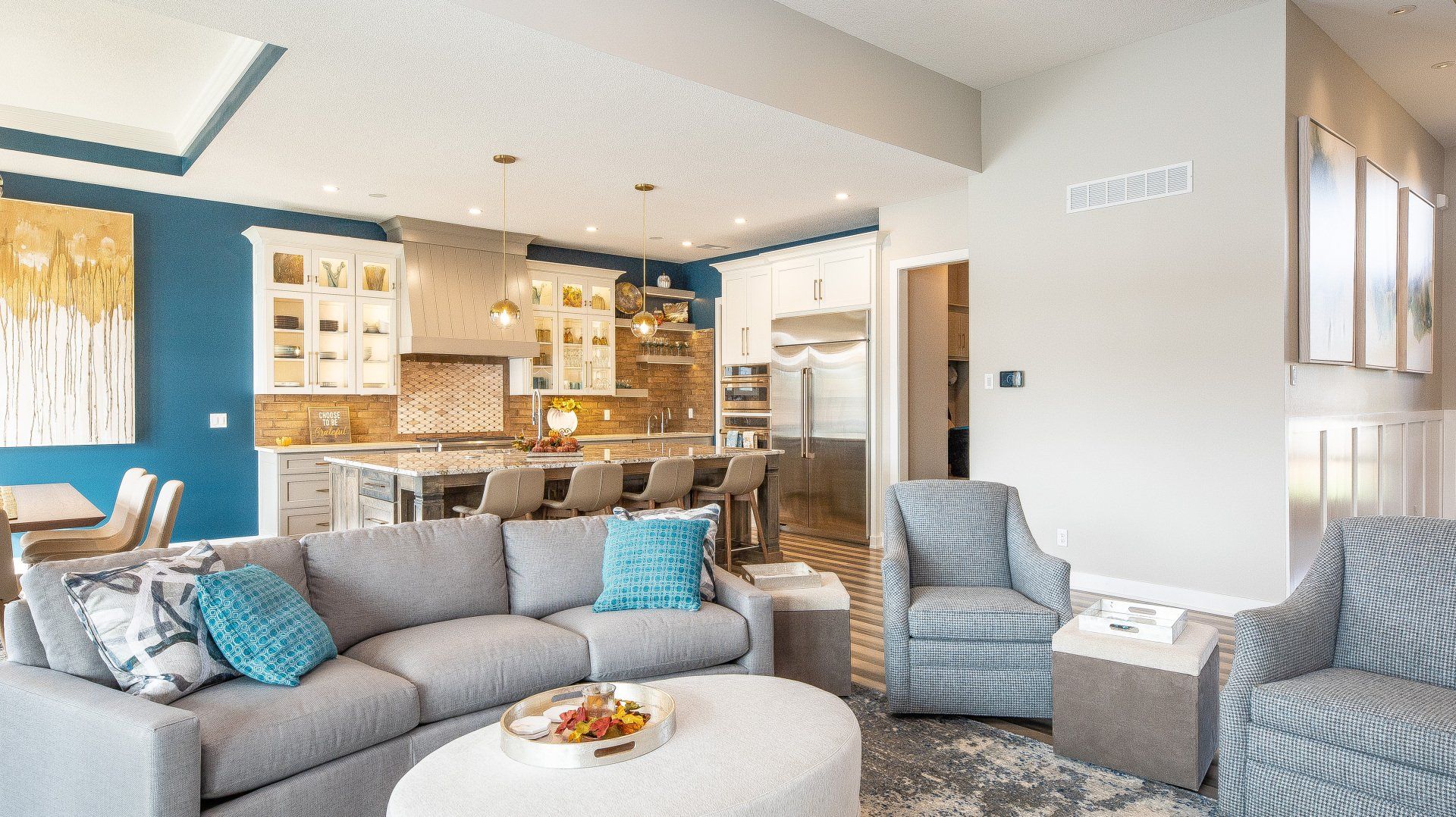 A living room with a couch , chairs , and a coffee table.