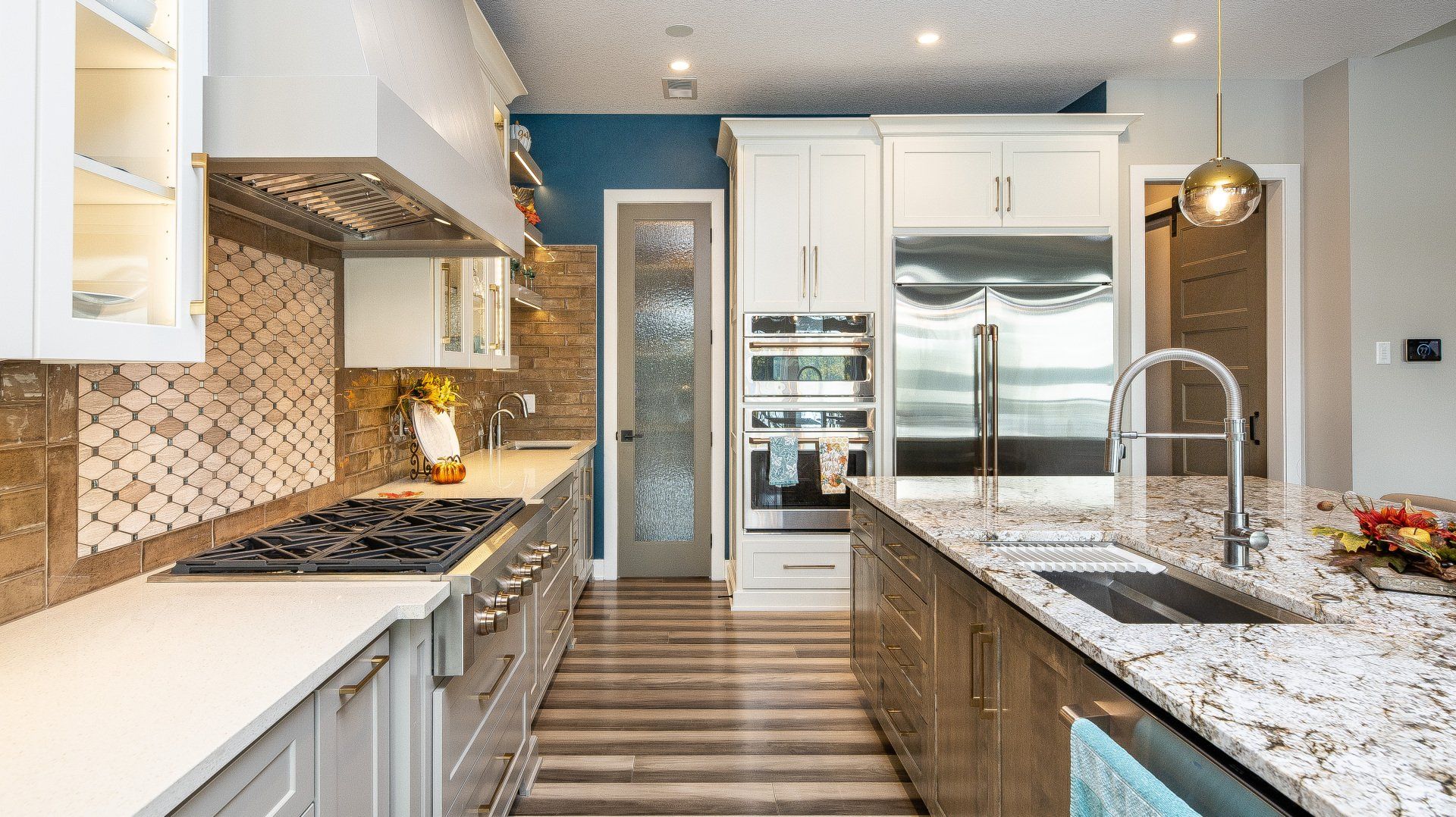 A kitchen with stainless steel appliances and granite counter tops.