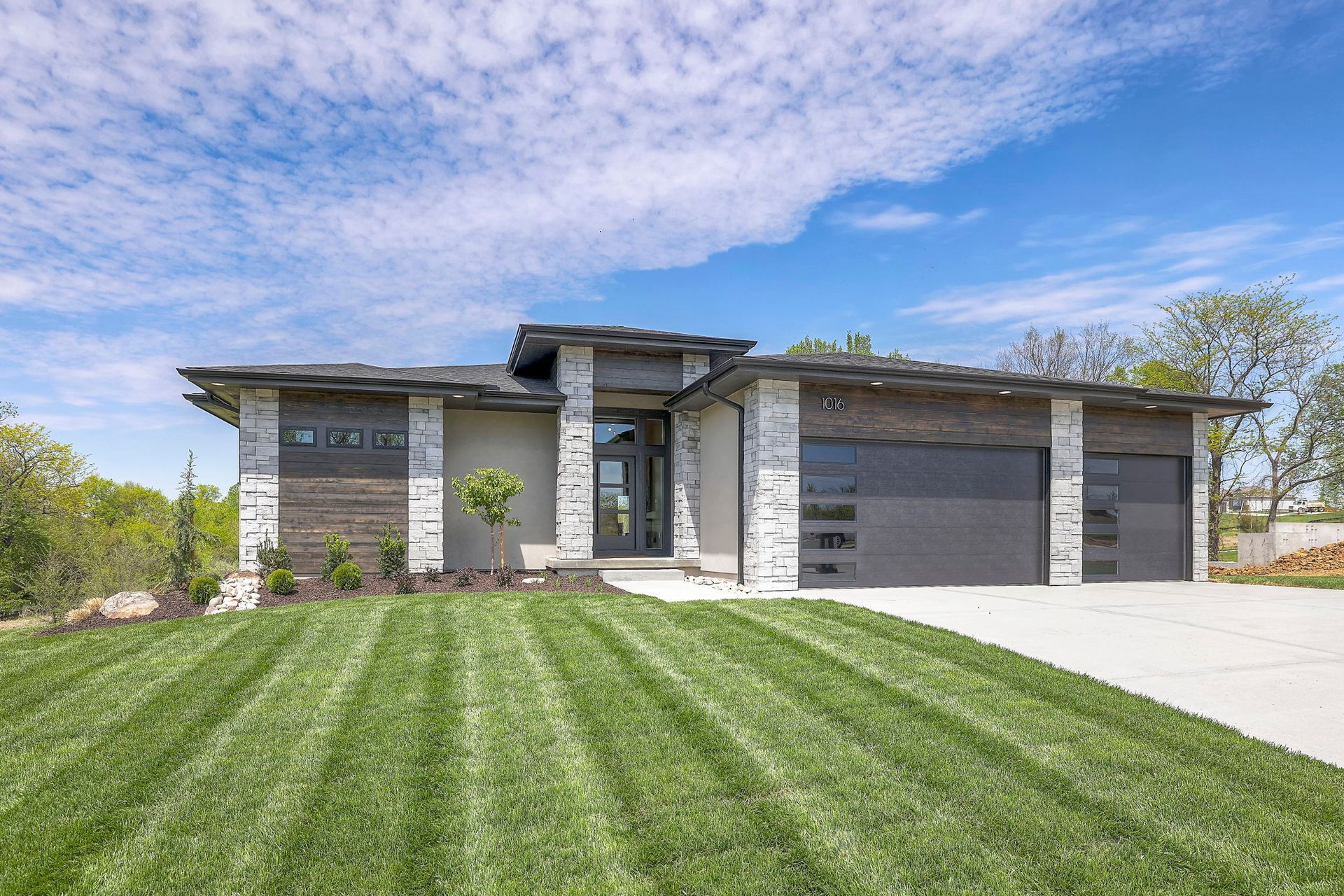 A large house with a lush green lawn in front of it.