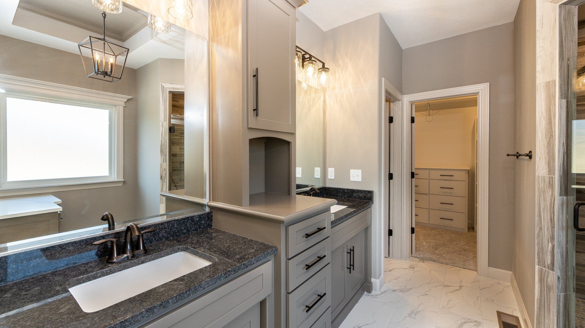 A bathroom with two sinks and a large mirror.