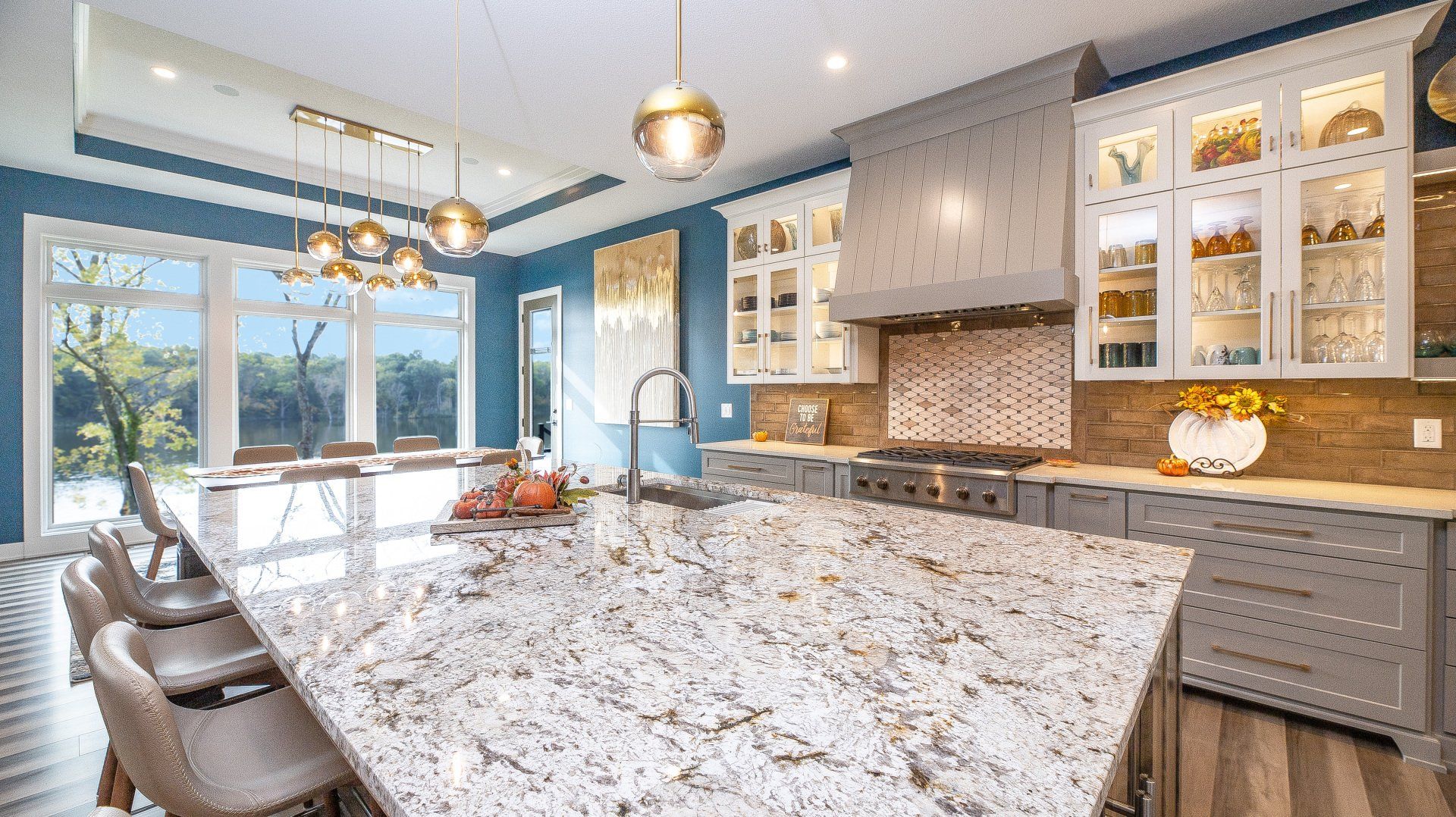 A kitchen with a large granite counter top and a large island.