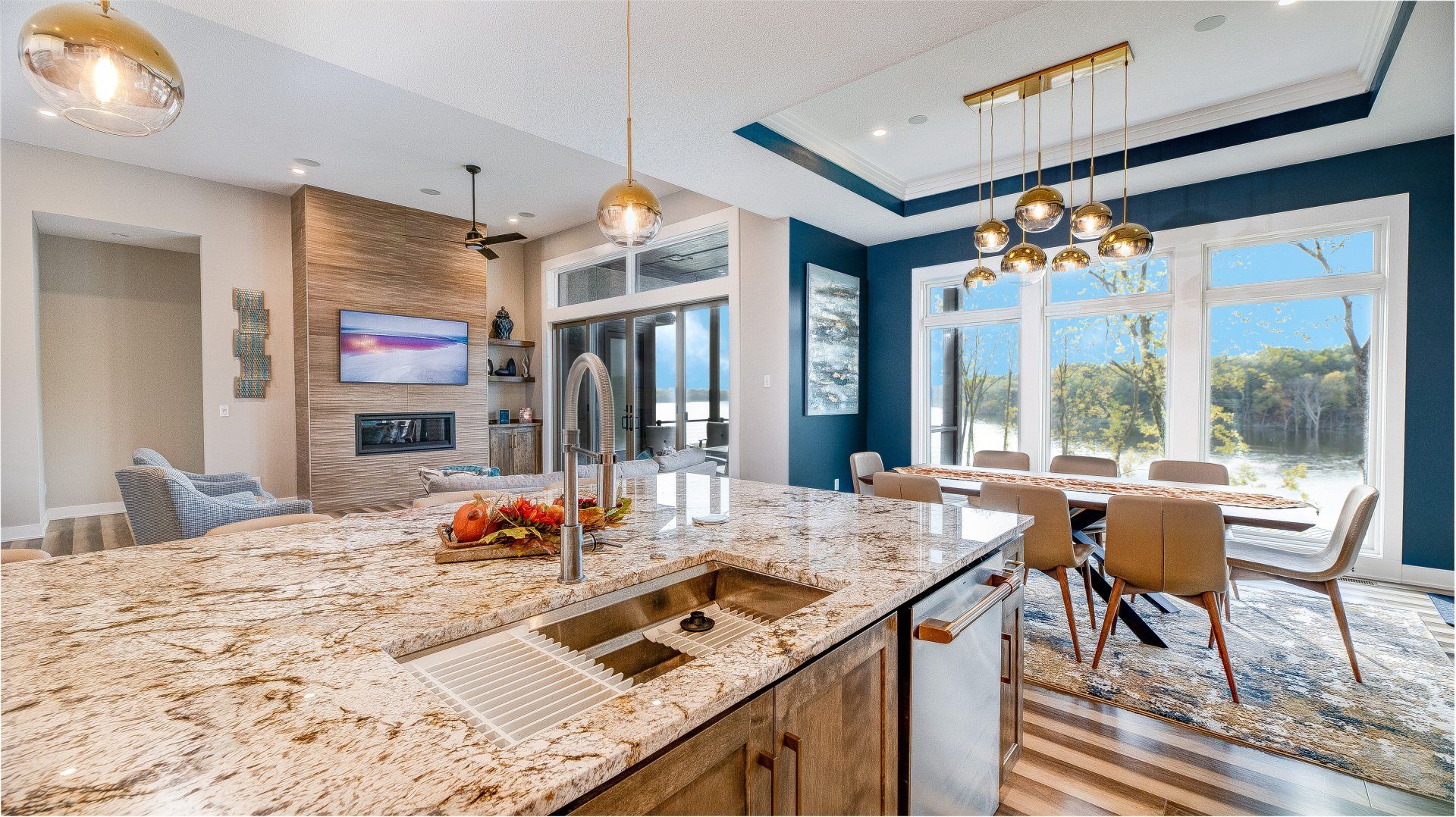 A kitchen with granite counter tops and a stainless steel sink.