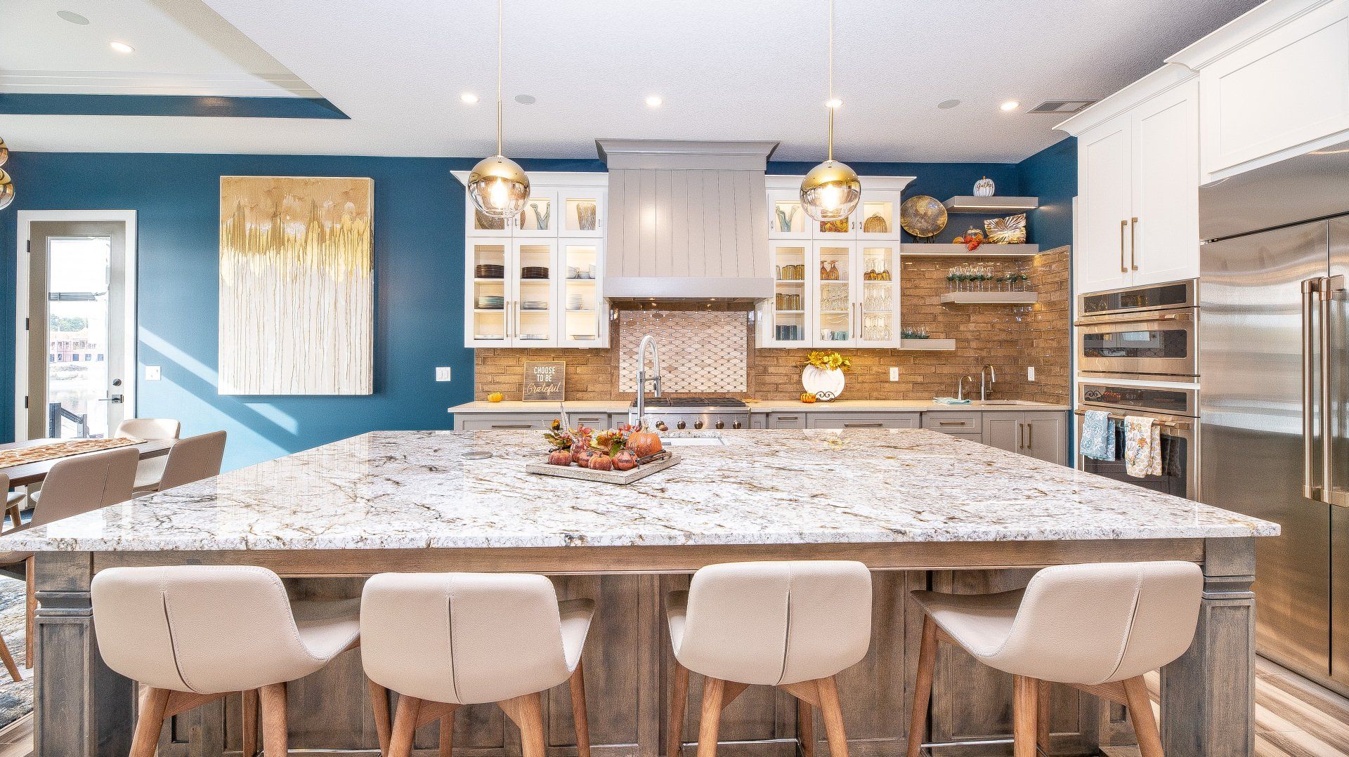 A kitchen with a large island and stools