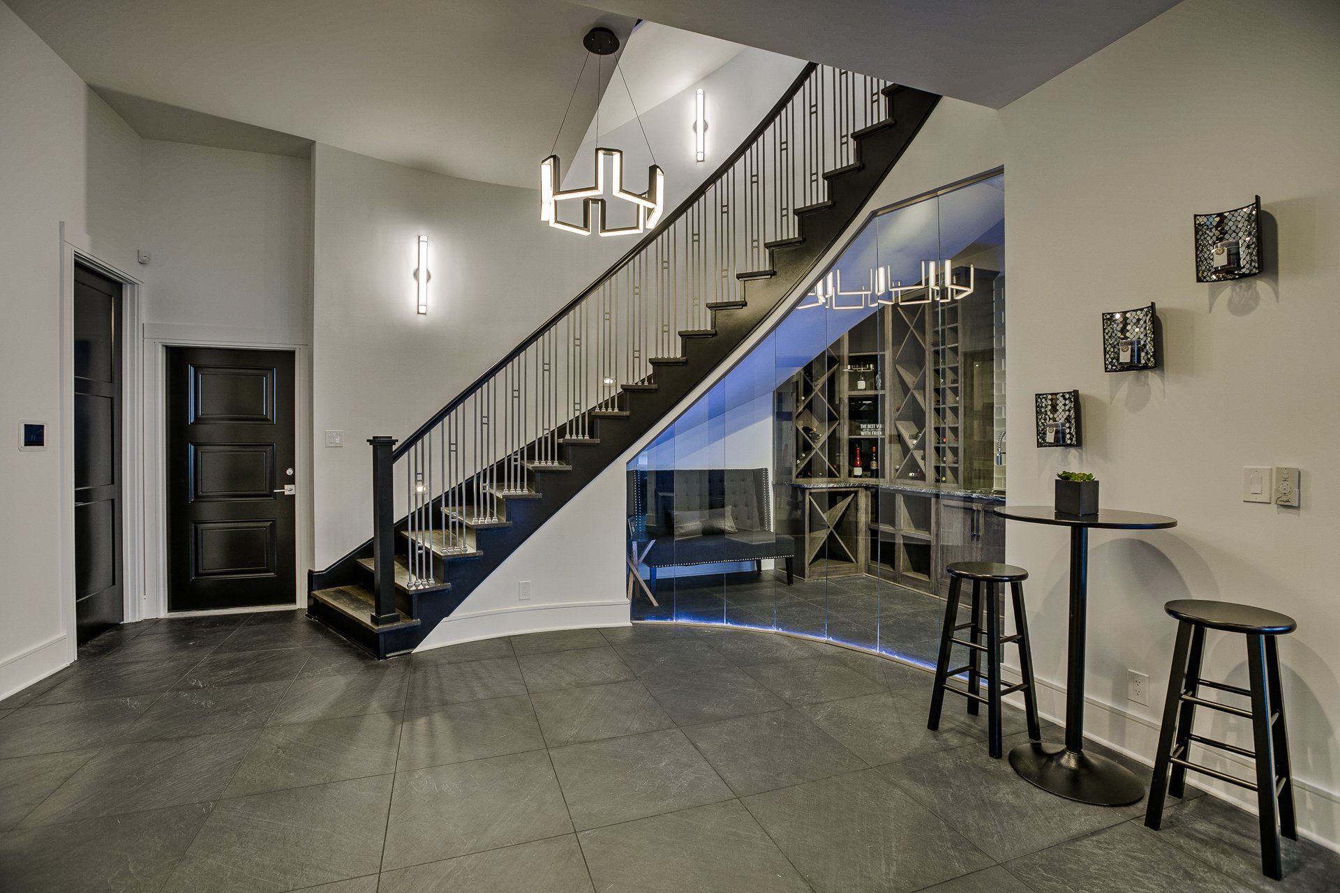 A hallway with a staircase leading up to a wine cellar