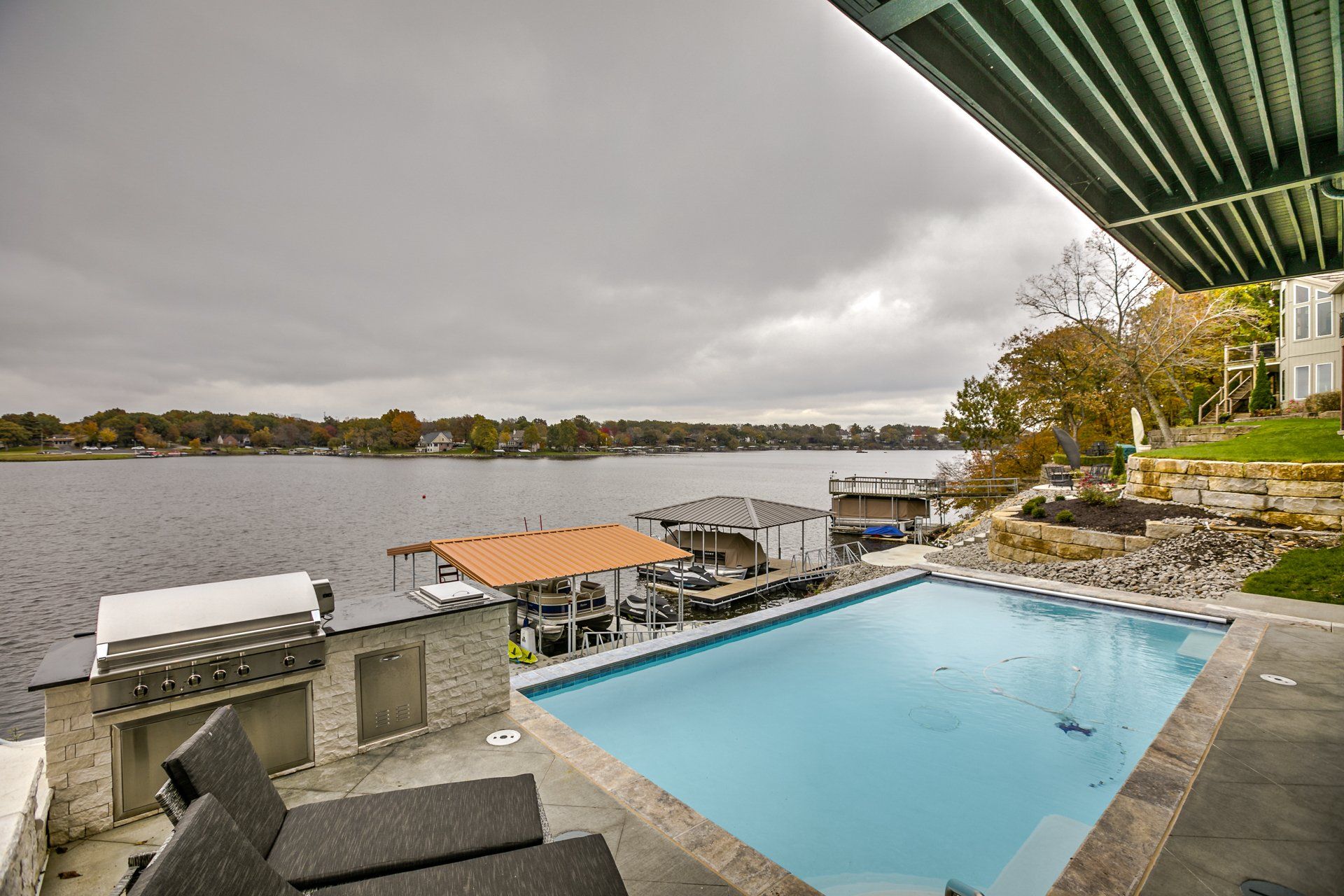 A large swimming pool with a view of a lake.