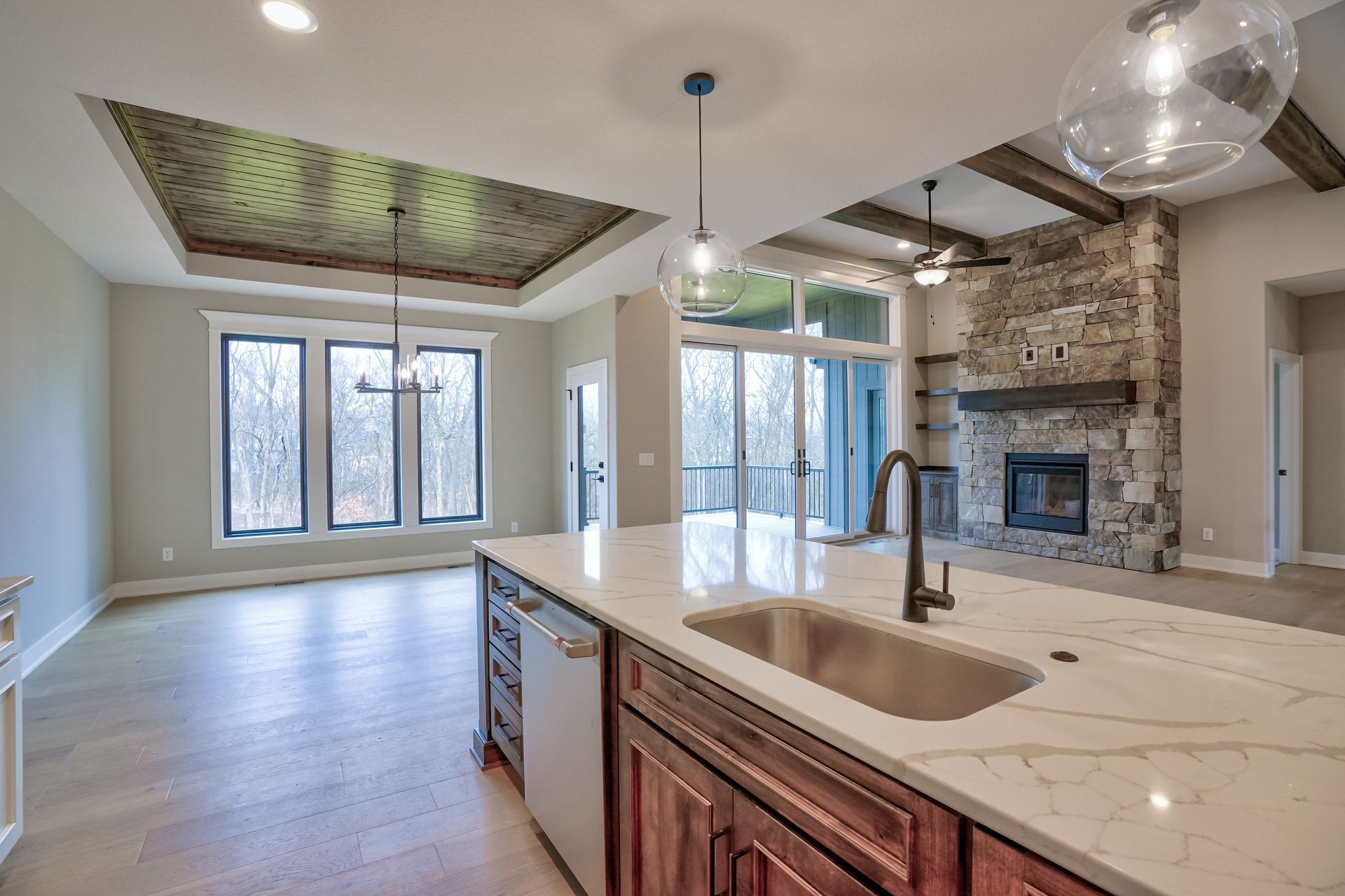 A kitchen with a sink and a fireplace in a house.