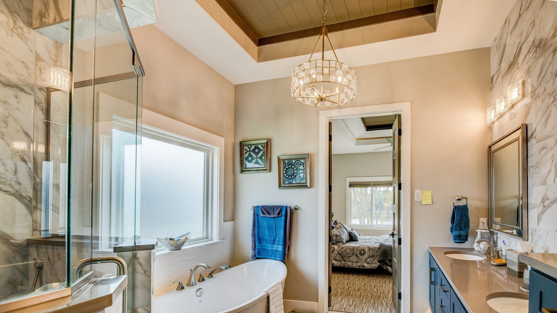 A bathroom with a bathtub , sinks , and a walk in shower.