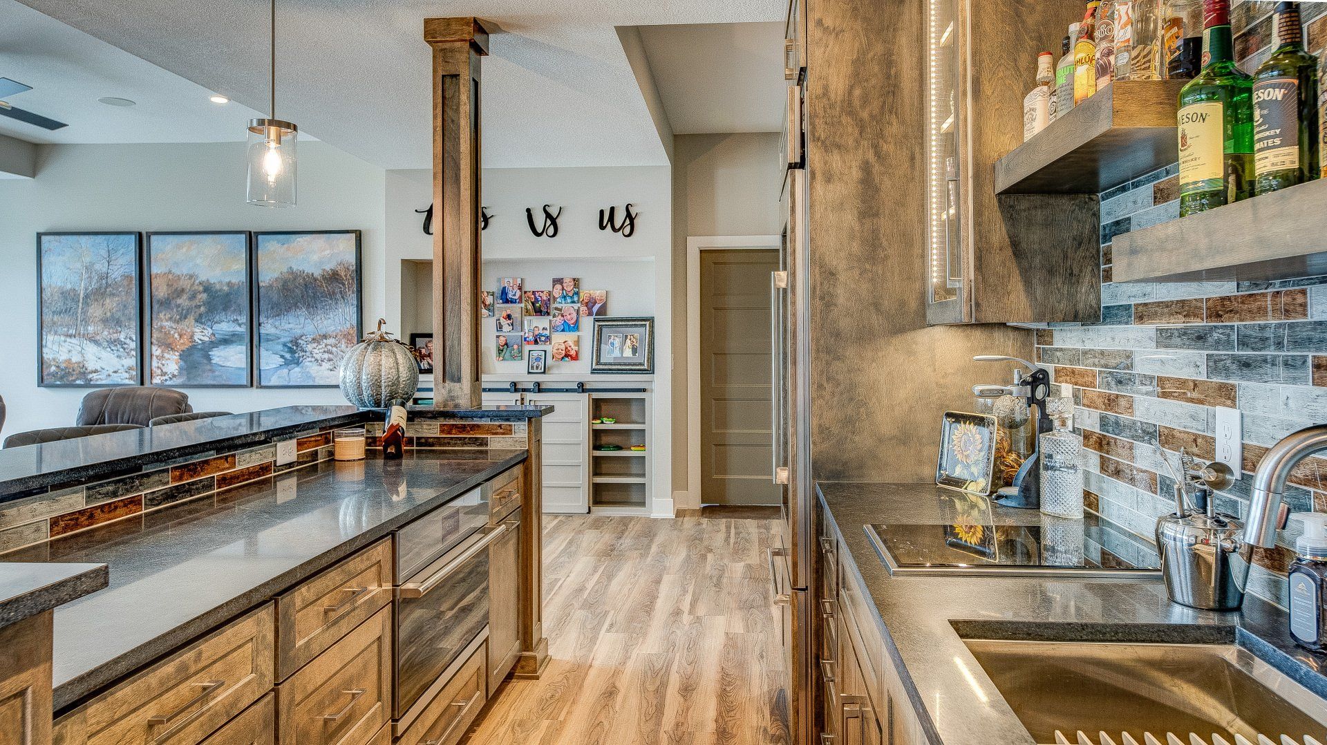 A kitchen with stainless steel appliances and wooden cabinets.