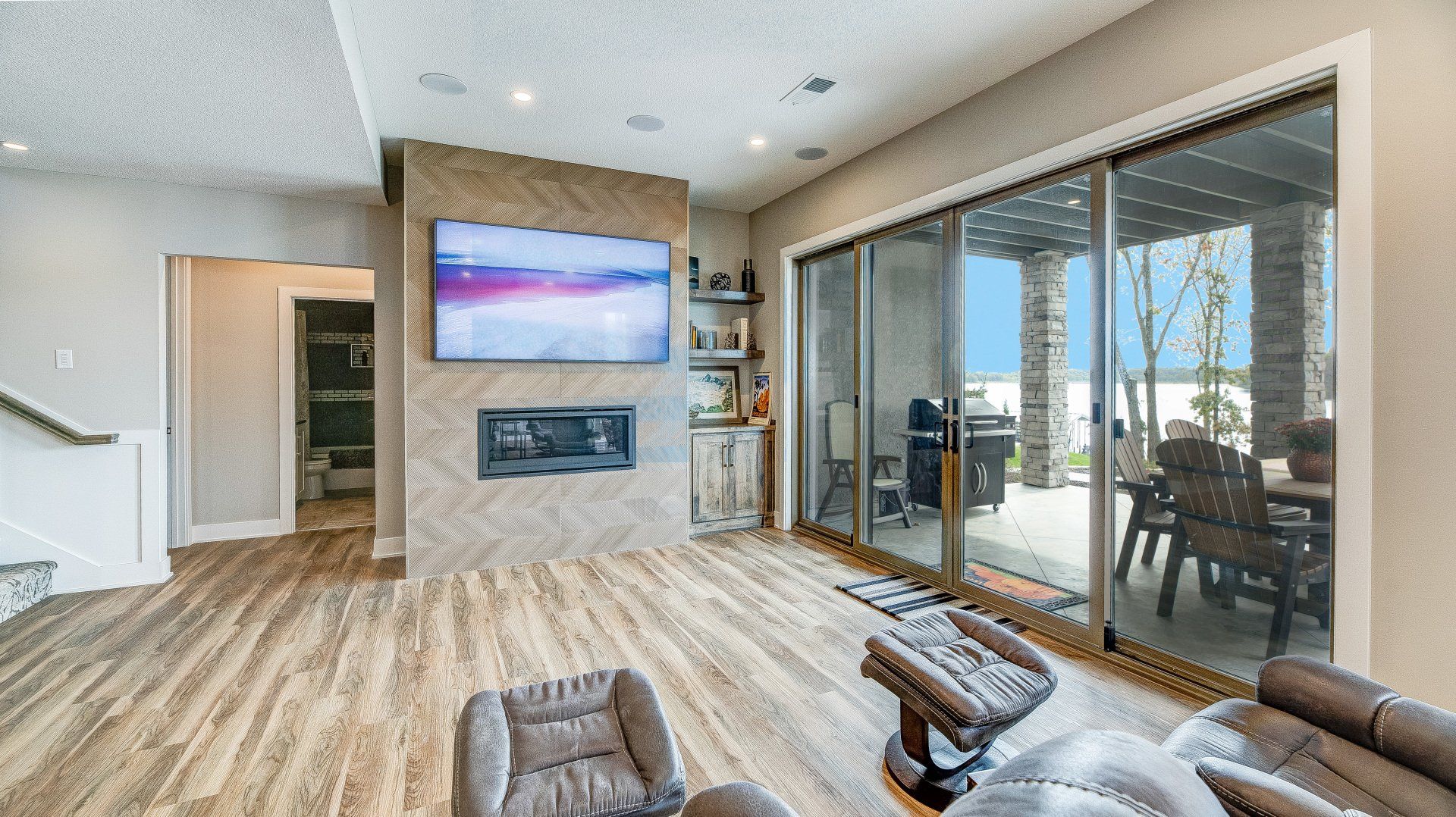 A living room with hardwood floors and a flat screen tv on the wall.