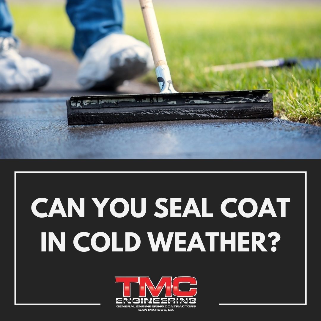 A person is using a broom to seal a driveway in cold weather.