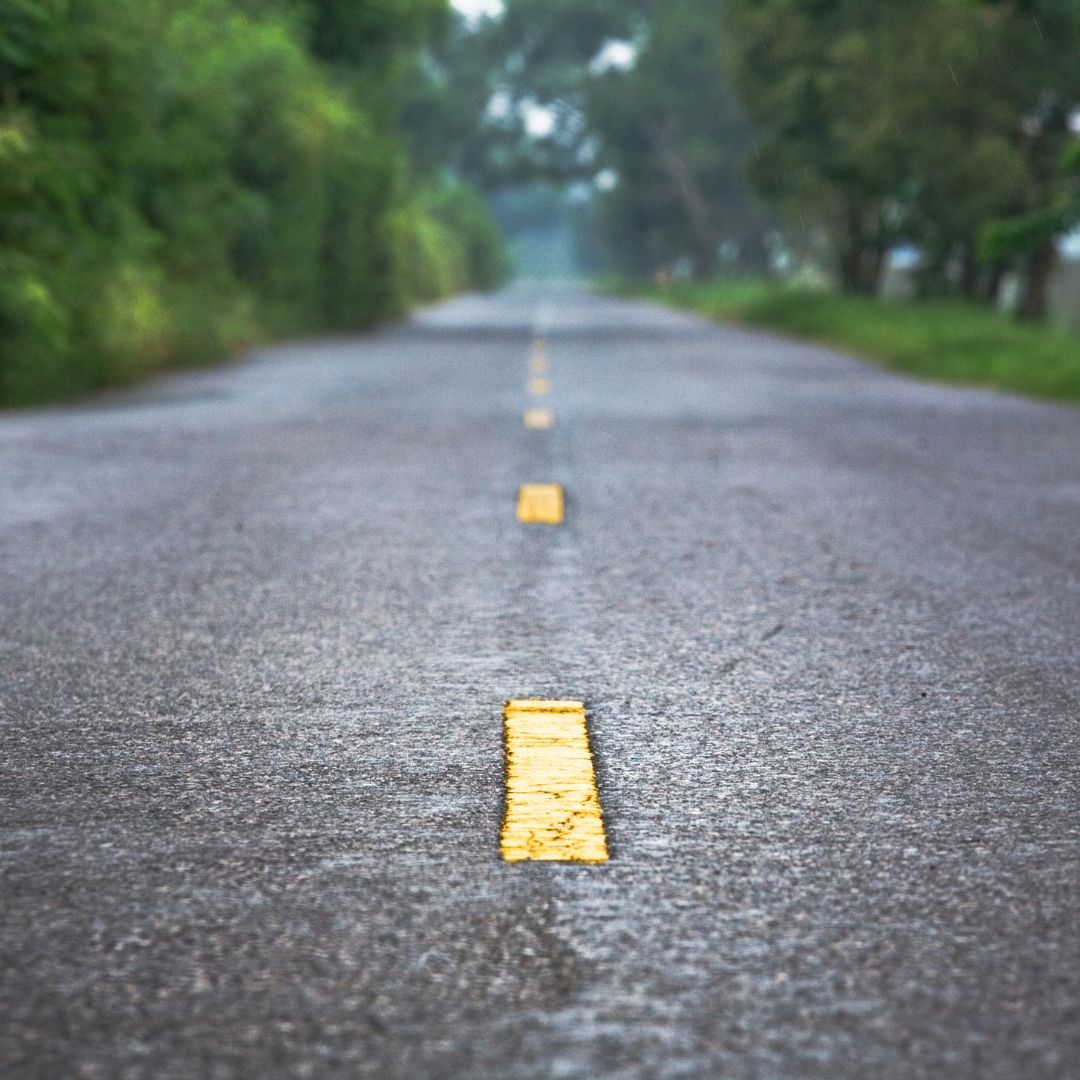 A road with a yellow line on the middle of it.