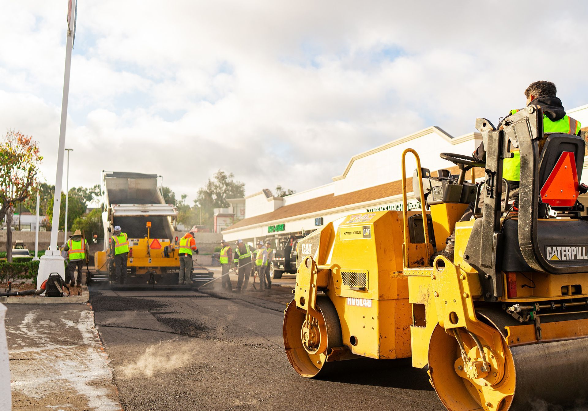 A group of construction workers are working on a road.
