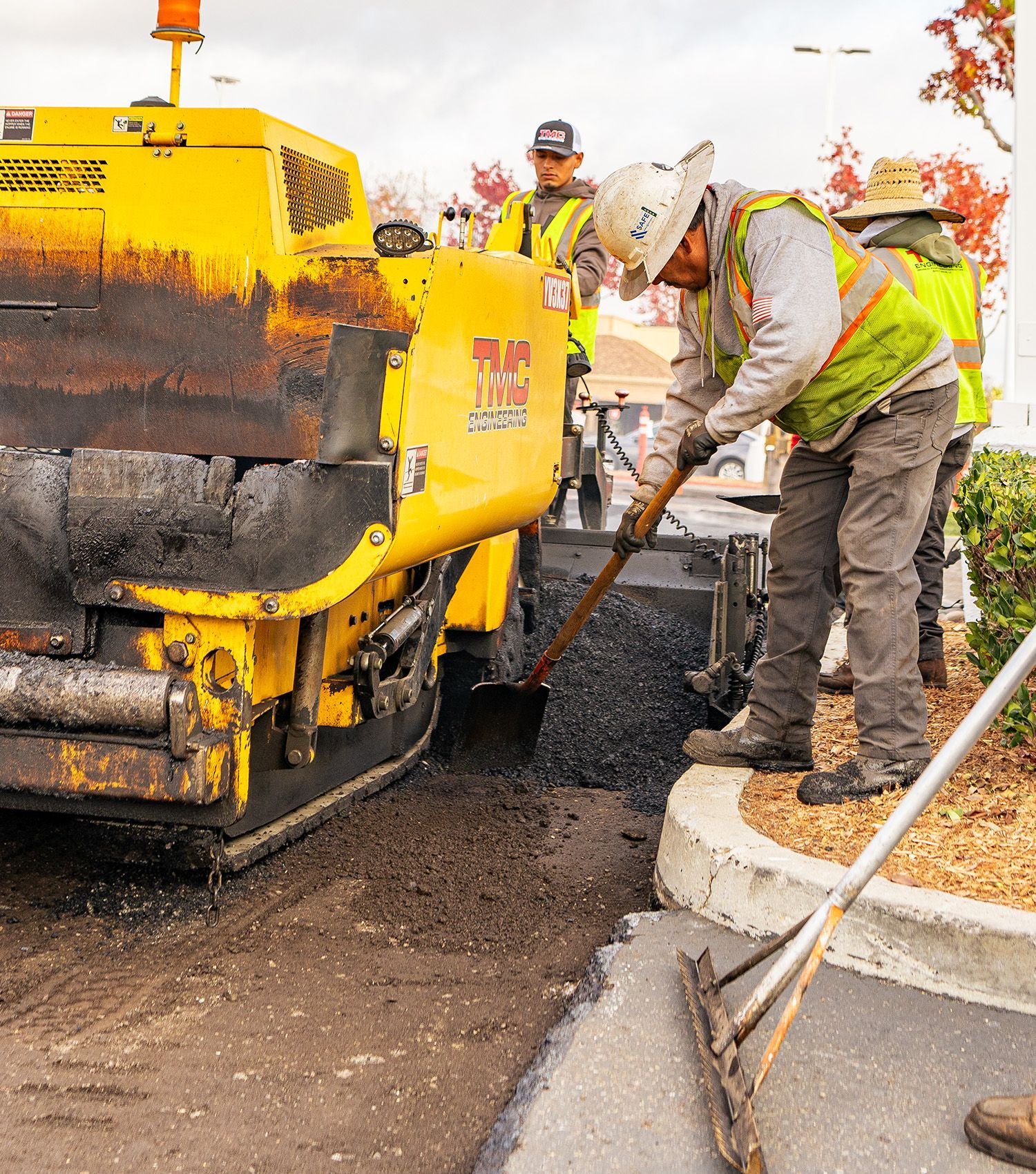 A group of construction workers are working on a road