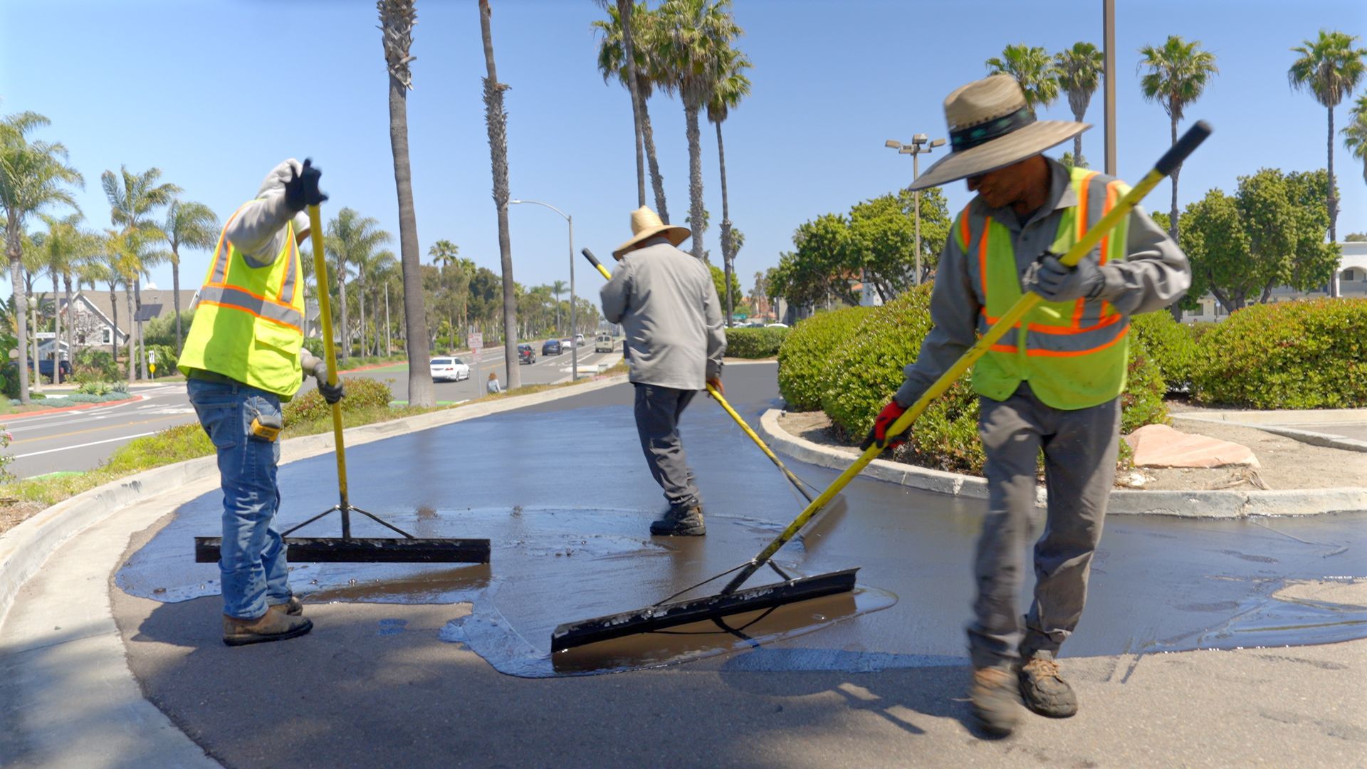 A group of construction workers are working on a road.
