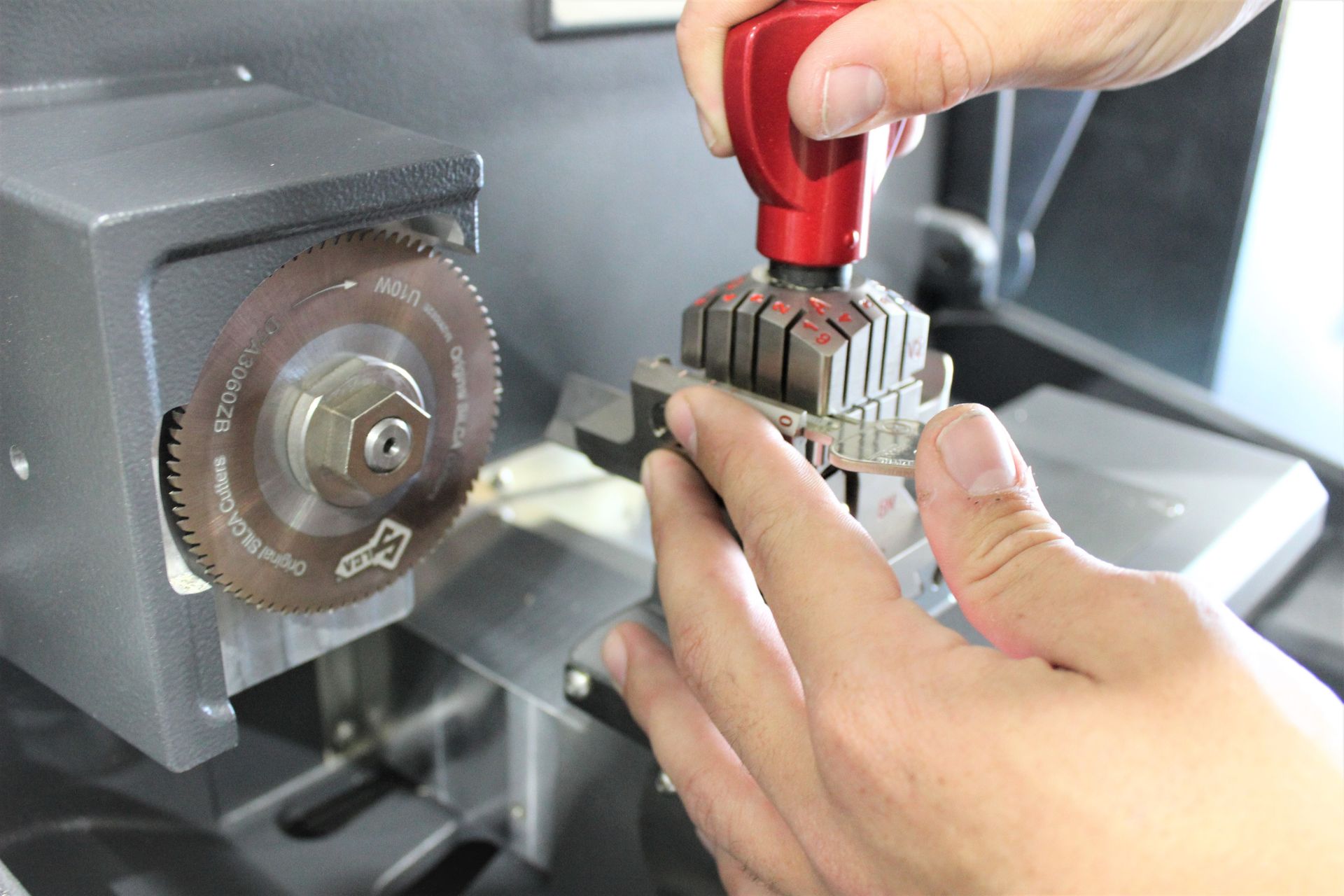 Residential Key Being Cut By Machine — Residential Locksmiths on the Sunshine Coast, QLD