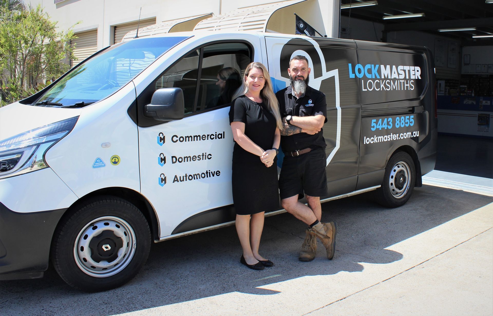 Man and women standing in front of van — Locksmiths on the Sunshine Coast, QLD