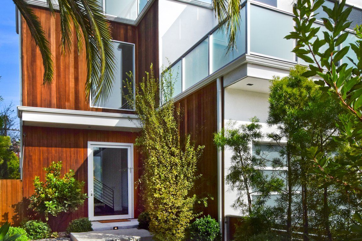 A modern house with a wooden facade and a balcony