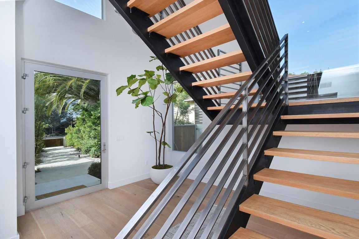 A staircase with wooden steps and a metal railing