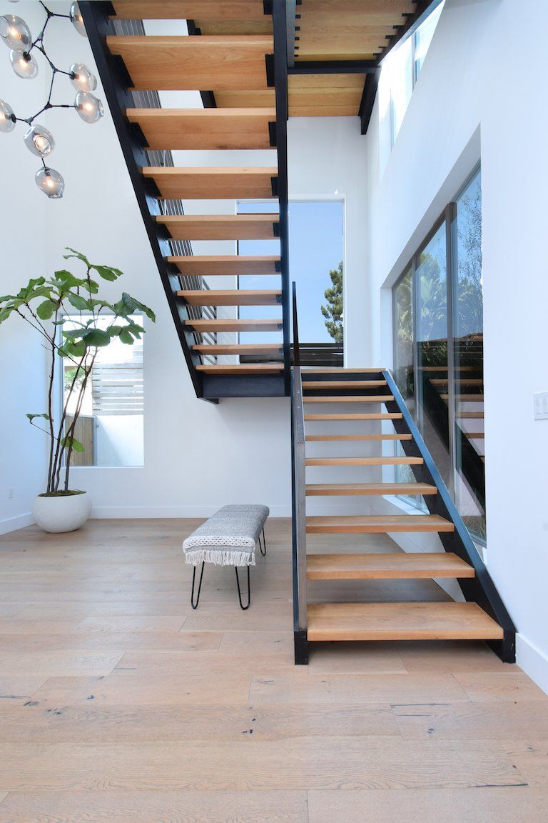 A wooden staircase leading up to the second floor of a house