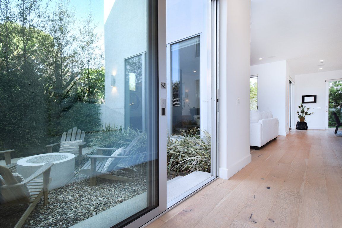 A hallway with a sliding glass door leading to a patio