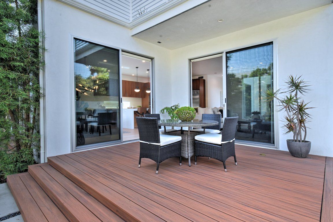 A wooden deck with a table and chairs on it