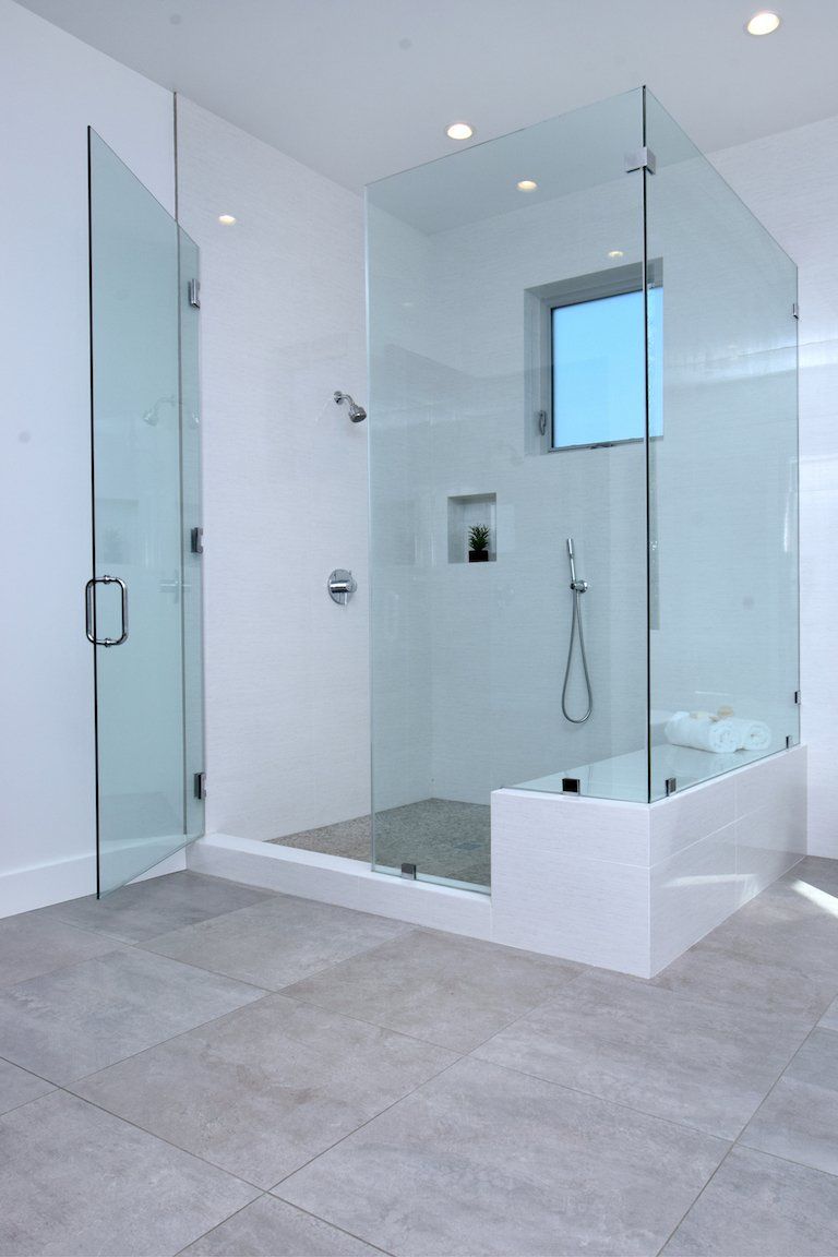 A bathroom with a walk in shower and a bathtub.
