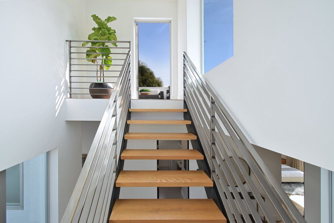 A staircase with wooden steps and a metal railing