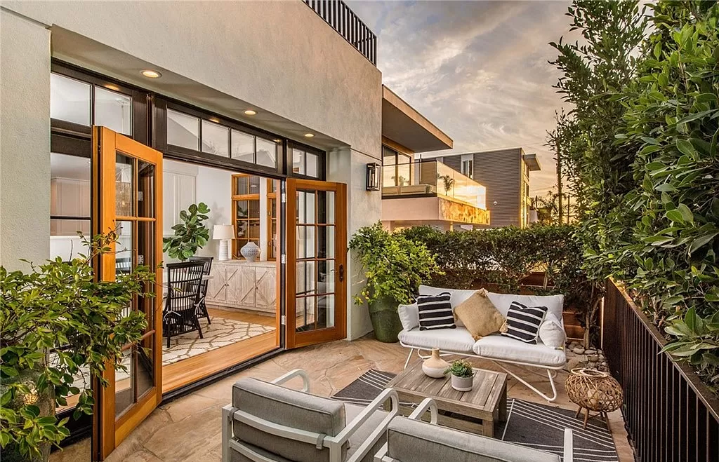 A large patio with a couch , chairs , and a table.