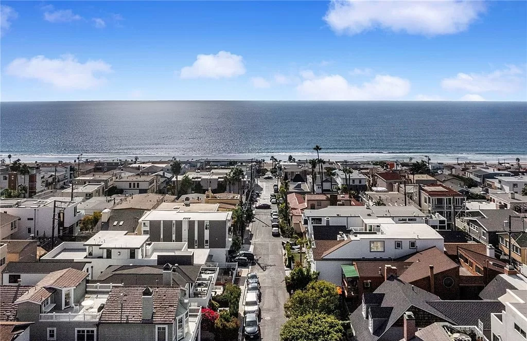 An aerial view of a city with the ocean in the background