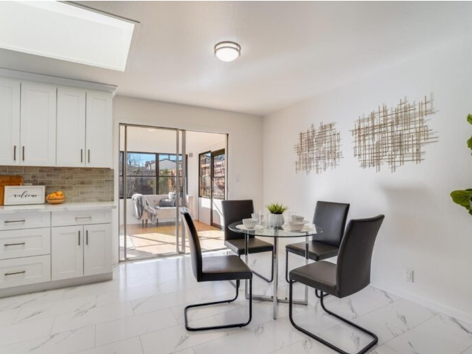 A dining room with a table and chairs in it
