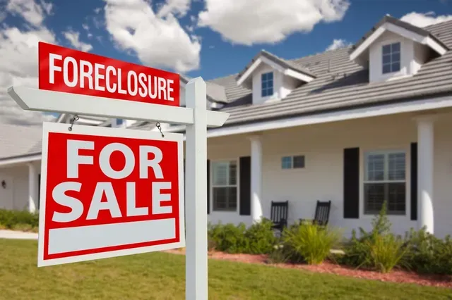 A house with a foreclosure sign in front of it