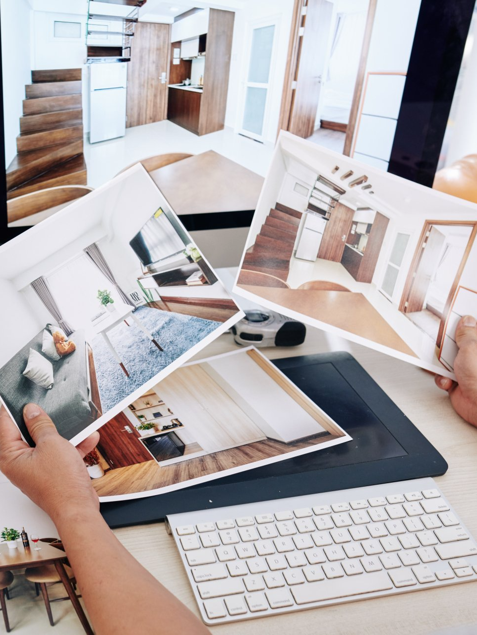 A person is looking at pictures of a house on a computer screen.