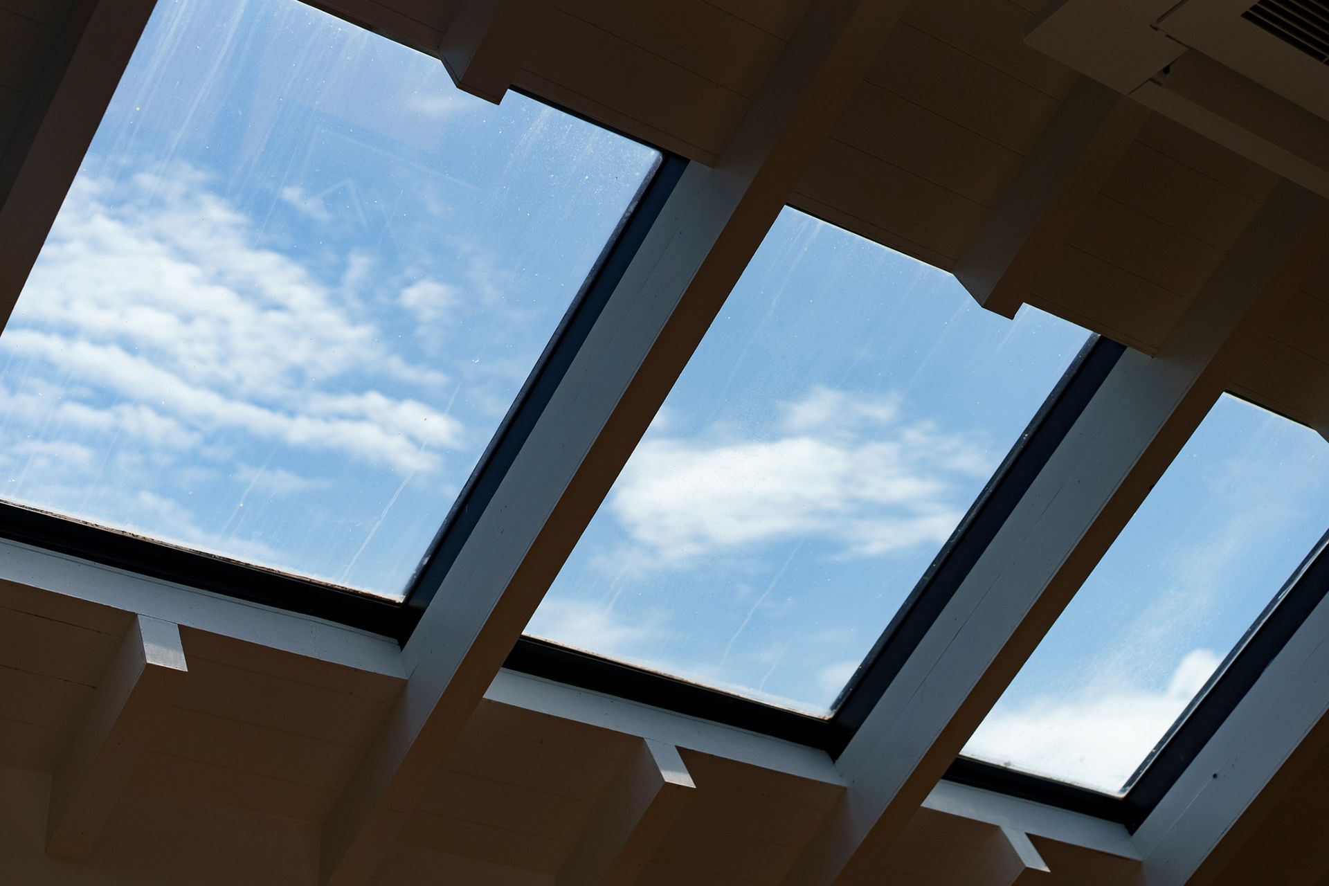 The sky is visible through the skylights of a building
