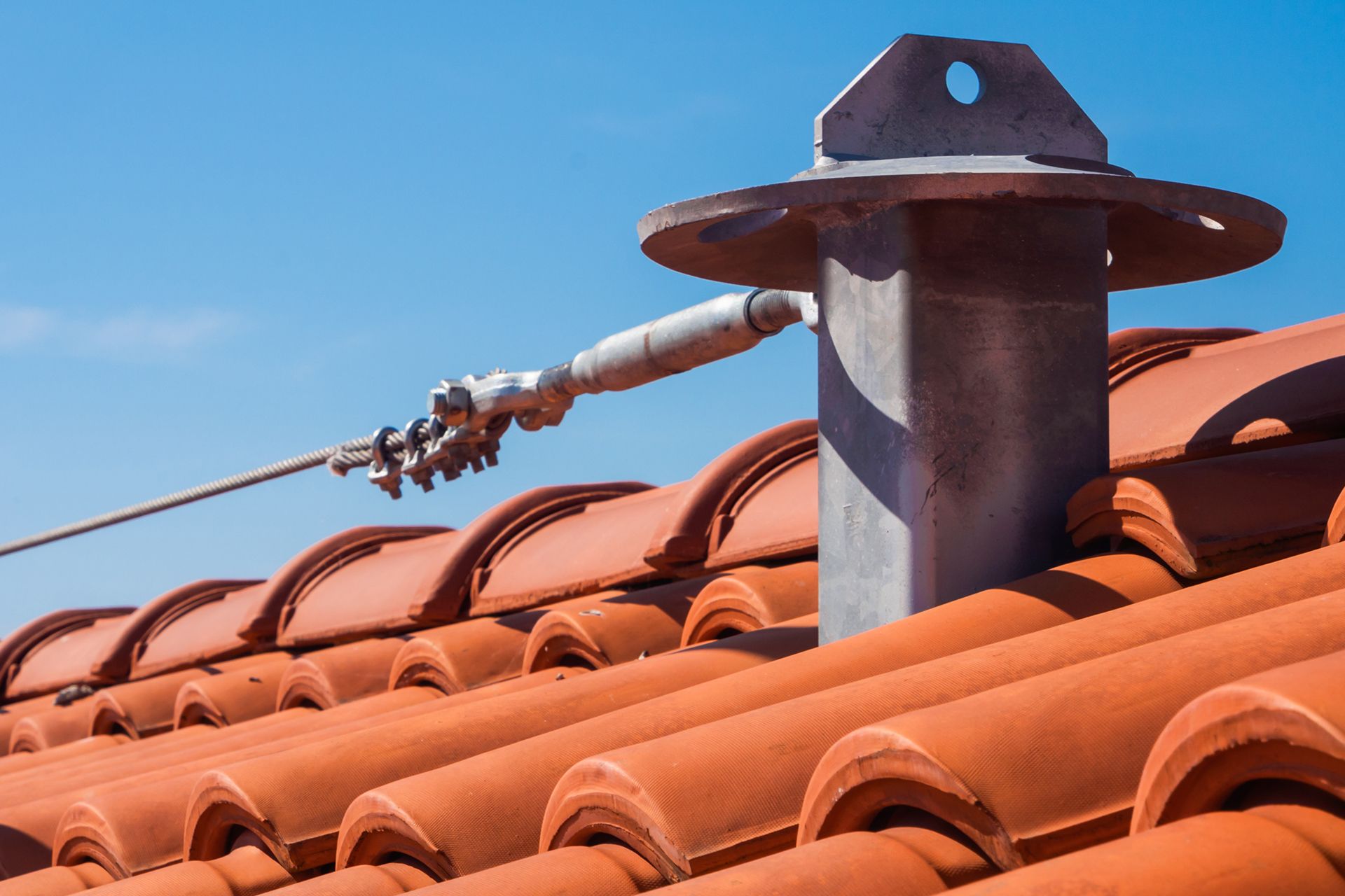 There is a chimney on the roof of a building.