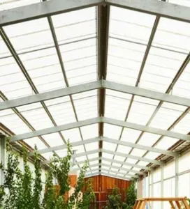 A greenhouse with a clear roof and lots of windows