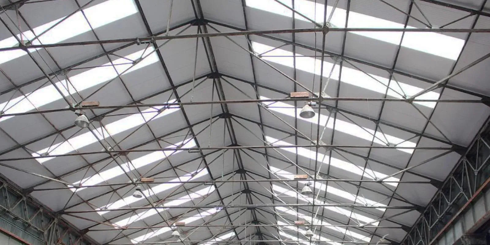 Looking up at the ceiling of a building with a lot of windows.