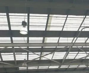 A light is hanging from the ceiling of a building.