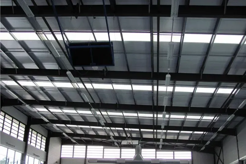 A large warehouse with a ceiling that has a lot of lights on it