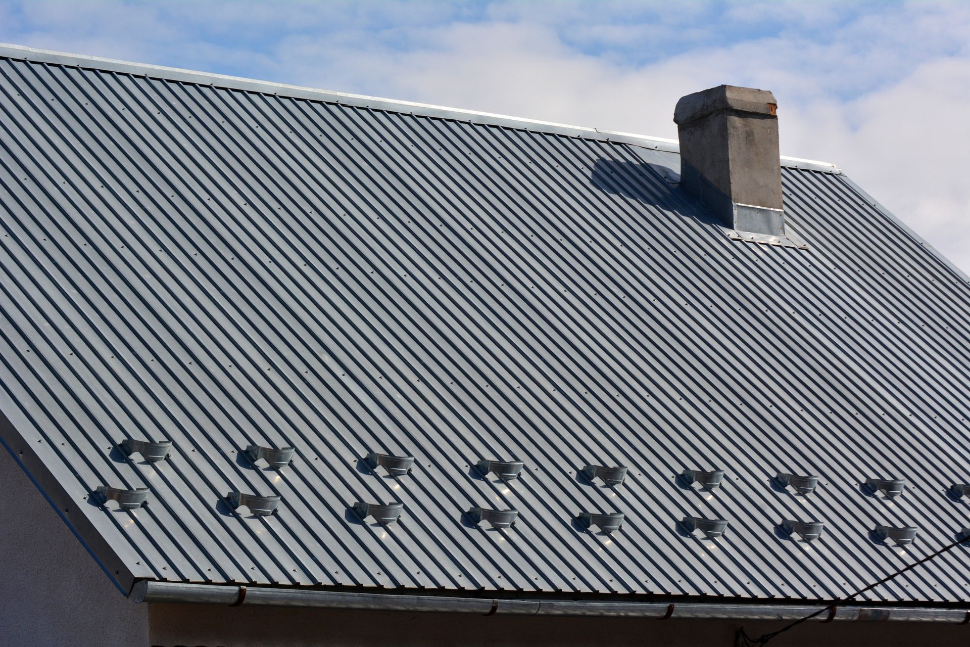 A building topped with a durable profiled metal sheet roof. A building topped with a durable profiled metal sheet roof.