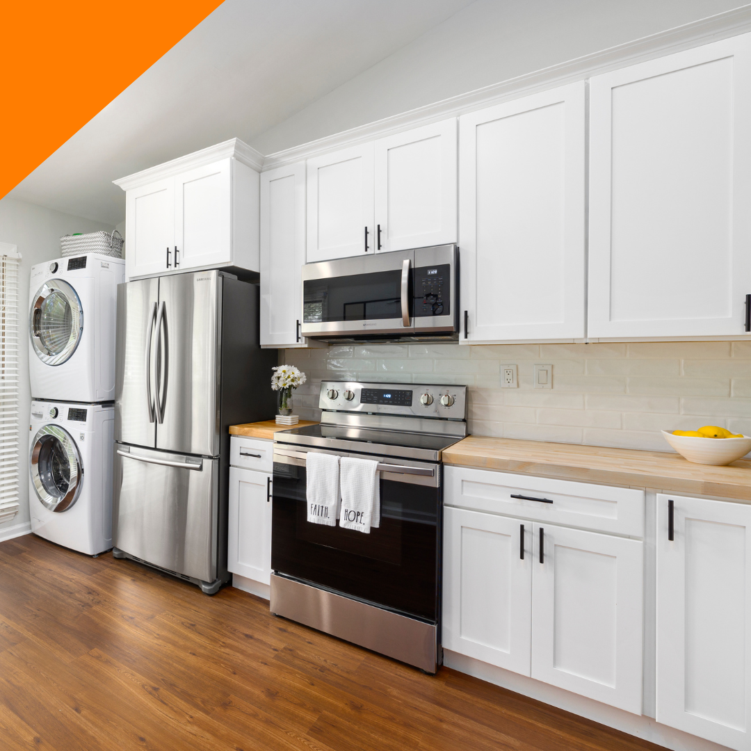 A kitchen with white cabinets and stainless steel appliances.