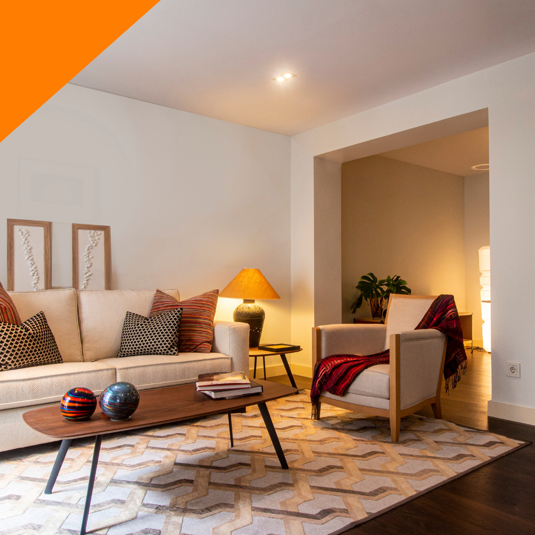 A living room with a couch , chair , coffee table and rug