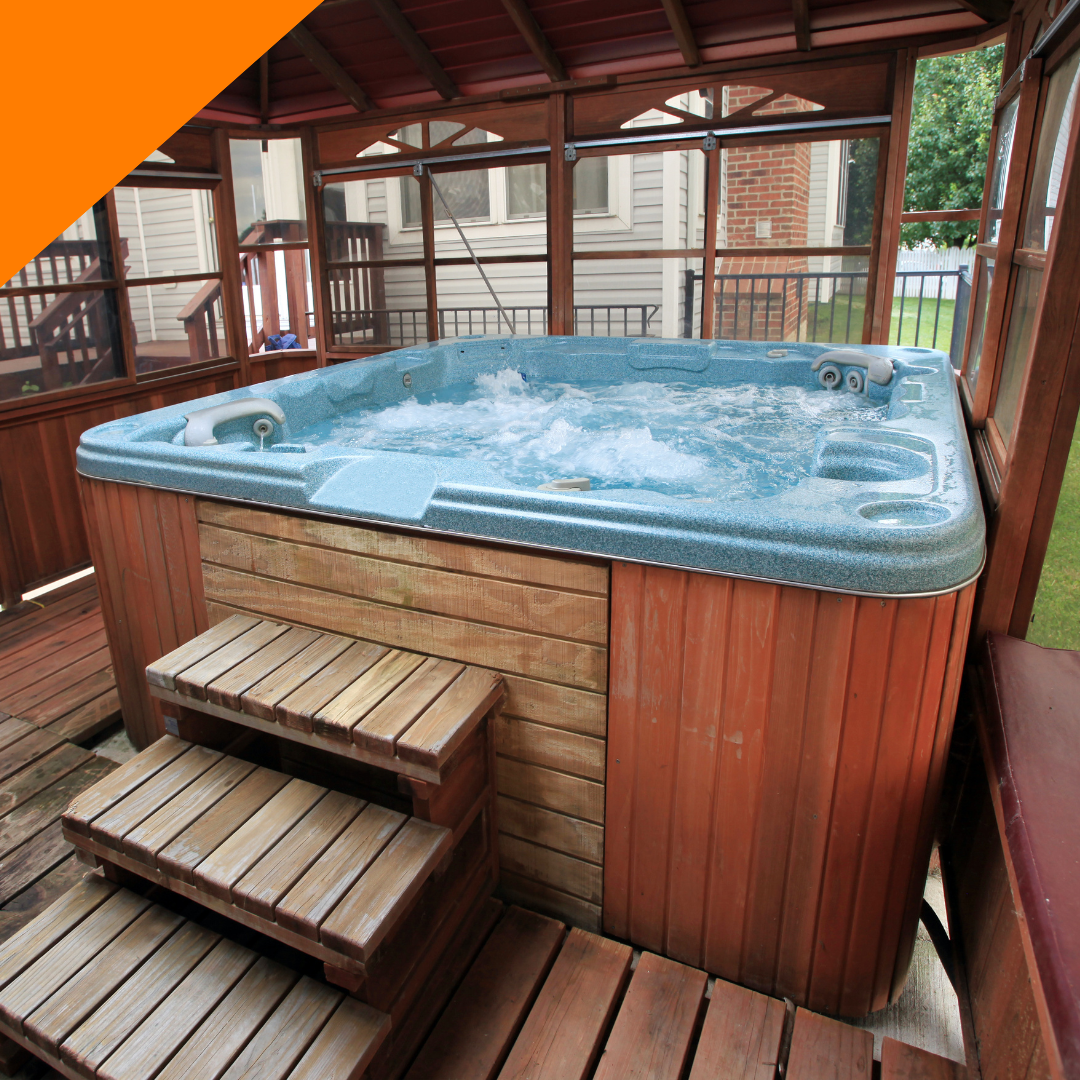A blue hot tub is sitting on a wooden deck
