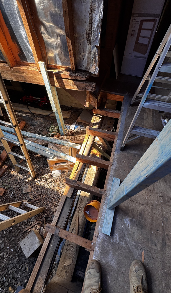 Rusty metal beams and wooden planks in a narrow construction or demolition space, viewed from above Rusty metal beams and wooden planks in a narrow construction or demolition space, viewed from above
